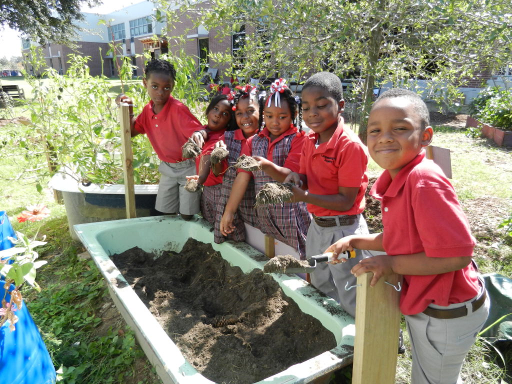 students planting in the reclaimed materials garden at LHA